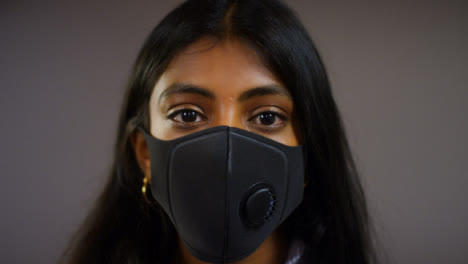 Young-Woman-Wearing-Face-Mask-Pull-Focus