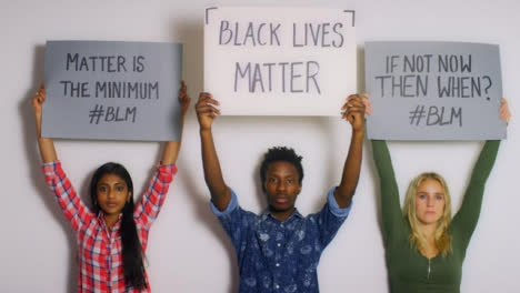 3-Young-People-Holding-Up-Black-Lives-Matter-Signs