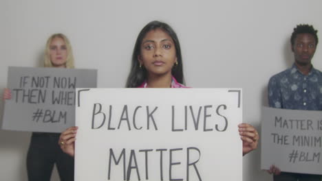 3-Young-People-Holding-Anti-Racism-Signs