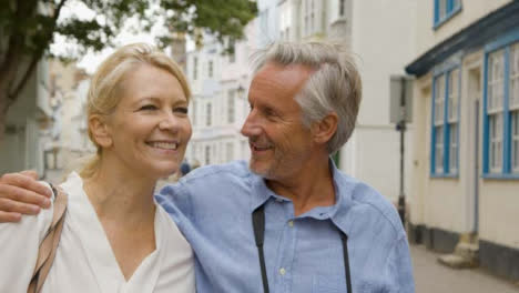 Tracking-Close-Up-of-Middle-Aged-Tourist-Couple-Reviewing-Their-Photos-