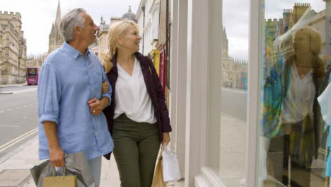 Medium-Shot-of-Middle-Aged-Tourist-Couple-Window-Shopping