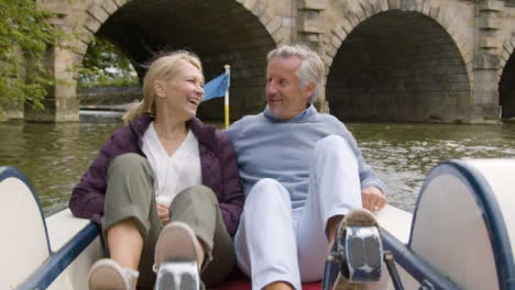 Medium-Shot-of-Middle-Aged-Tourist-Couple-In-Pedal-Boat