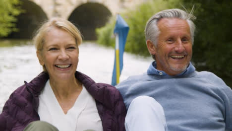 Close-Up-of-Middle-Aged-Tourist-Couple-In-Pedal-Boat