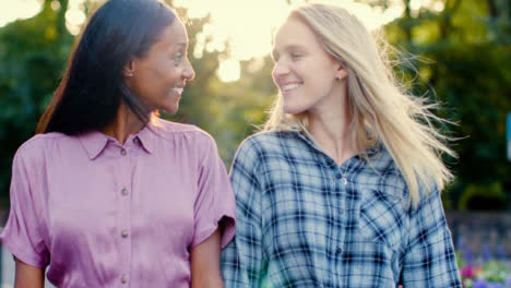 Tracking-Shot-of-Female-Couple-Laughing-and-Walking-Together