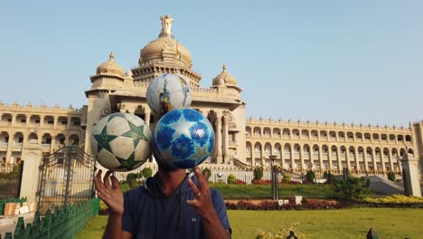 India--An-artist-performing-tricks-with-footballs-in-front-of-Vidhana-Soudha-building-in-Bengaluru-Karnataka-India-during-early-morning