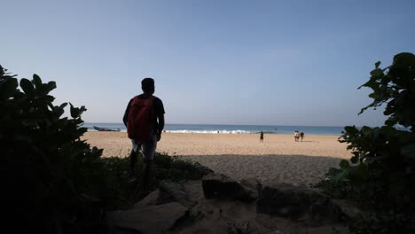 Wide-angle-reveal-shot-of-Varakala-beach-in-Kerala-India-on-a-bright-and-sunny-morning-with-waves-hitting-the-shore
