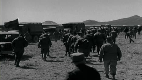 1955-American-Military-Personnel-Walking-to-Transport-Vehicles-In-the-Desert--