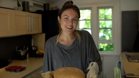 Young-Woman-Proud-of-Freshly-Baked-Bread-Loaf
