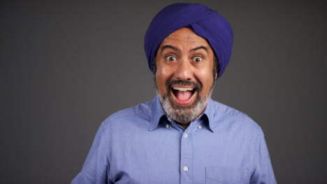 Middle-Aged-Man-In-Turban-Laughing-and-Celebrating-Good-News