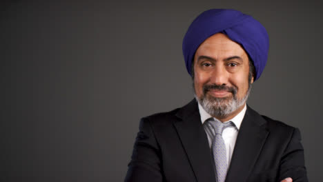 Middle-Aged-Businessman-In-Turban-Folding-Arms-and-Smiling