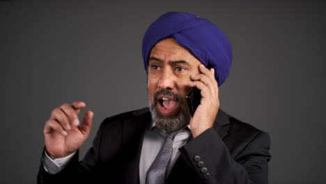 Frustrated-Middle-Aged-Businessman-In-Turban-Shouting-On-Phone