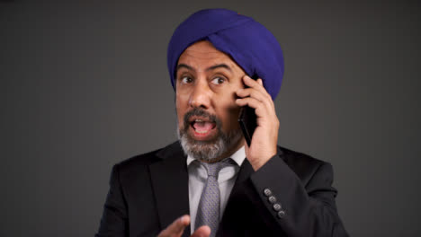 Furious-Middle-Aged-Businessman-In-Turban-Shouting-On-Phone