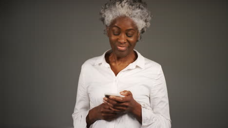 Smartly-Dressed-Woman-Smiling-to-Herself-While-Texting-Portrait
