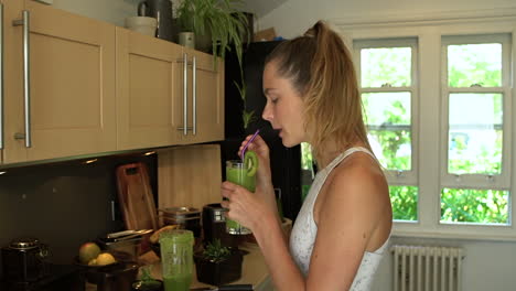 Young-Woman-Drinking-Green-Fruit-Smoothie