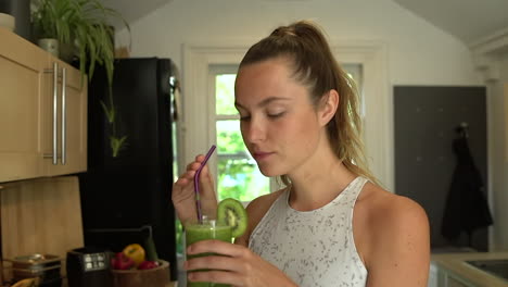 Close-Up-of-Young-Woman-Drinking-Green-Fruit-Smoothie