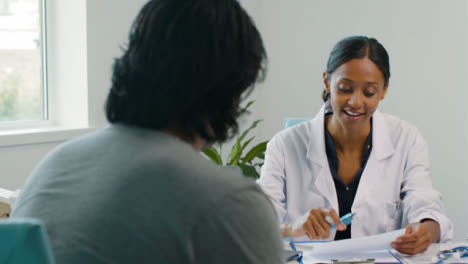 Happy-Female-Doctor-Talking-With-Patient