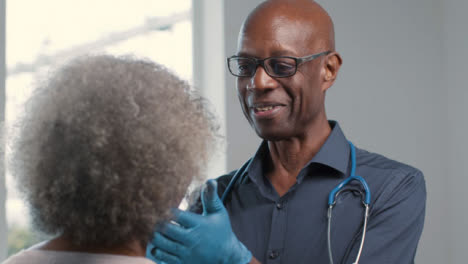 Positive-Middle-Aged-Doctor-Performing-Medical-Check-Up-