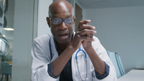 Middle-Aged-Doctor-Leading-Briefing-During-Video-Call