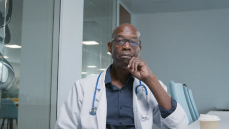 Middle-Aged-Doctor-Listening-During-Video-Meeting