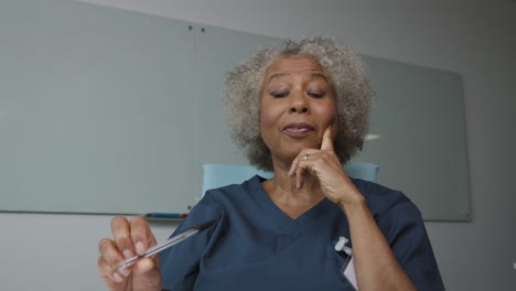 Middle-Aged-Female-Doctor-Reacting-During-Video-Call-Meeting