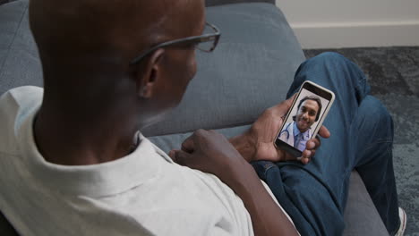 Middle-Aged-Man-Having-Video-Phone-Consultation-with-Doctor