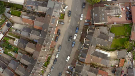 Drone-Shot-Car-Driving-Down-Housing-Estate-Street