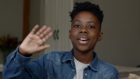 Young-Boy-Listening-and-Waving-Goodbye-During-Video-Call