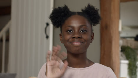 Young-Girl-Talking-and-Waving-Goodbye-During-Video-Call