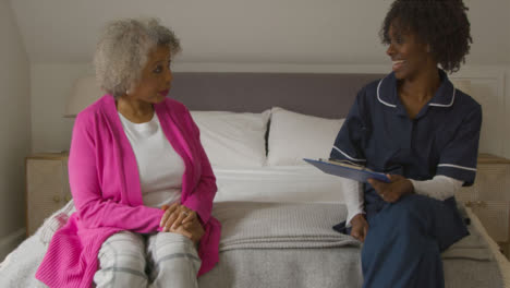 Middle-Aged-Nurse-Conducts-Home-Visit-with-Senior-Woman