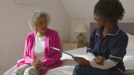 Middle-Aged-Nurse-Conducting-a-Home-Visit-with-Senior-Woman