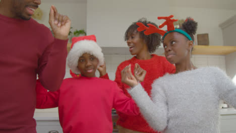 Fröhliche-Familie,-Die-Während-Des-Weihnachtsvideoanrufs-Spielerisch-Zusammen-Tanzt