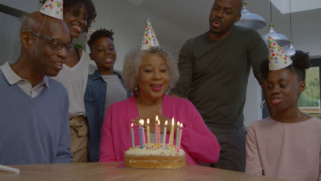 Family-Singing-Happy-Birthday-for-Elderly-Relative-Before-She-Blows-Out-Candles