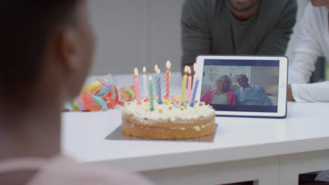 Family-Having-Video-Call-with-Grandparents-Singing-Happy-Birthday-for-Young-Daughter