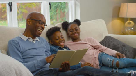 Grandfather-Reading-Story-Book-to-Grandchildren