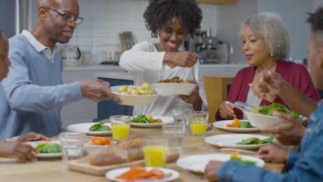 Family-Start-Plating-Up-Dinner-After-Saying-Grace-