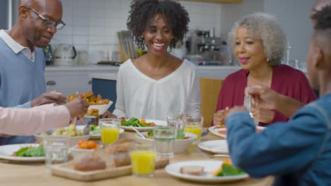 Family-Start-Plating-Up-Dinner-Together-at-Table-