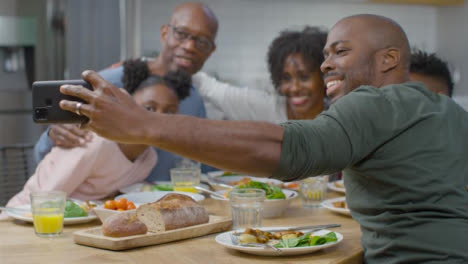 Family-Taking-Selfie-Together-During-Evening-Dinner