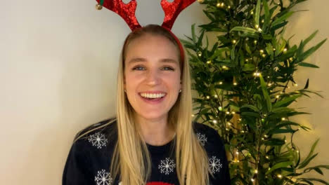Young-Woman-Joining-Christmas-Video-Call-Waving-and-Talking-Directly-to-Camera
