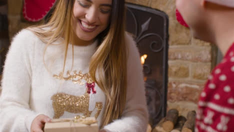 Close-Up-Shot-of-Young-Woman-Opening-Christmas-Gift-From-Boyfriend