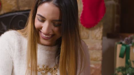 Close-Up-Shot-of-Young-Womans-Reaction-As-She-Opens-a-Christmas-Gift-From-Boyfriend