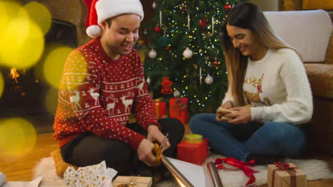 Wide-Shot-of-a-Young-Couple-Wrapping-Christmas-Presents-Together-