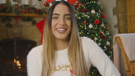 Young-Woman-Talking-and-Laughing-to-Camera-During-Christmas-Video-Call