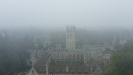 Drone-Shot-Approaching-Buildings-In-Misty-Oxford