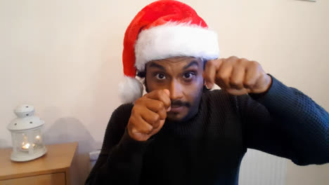 Young-Man-On-Christmas-Video-Call-Acting-Out-Word-During-Charades-Game