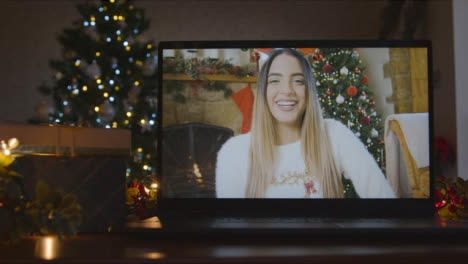 Close-Up-Shot-of-Young-Woman-During-Video-Call-On-Laptop-Screen-In-Christmas-Environment