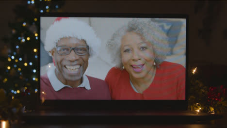 Close-Up-Shot-of-a-Senior-Couple-During-Video-Call-On-Laptop-Screen-In-Christmas-Environment