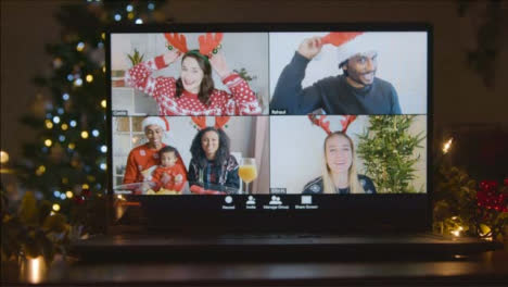 Sliding-Shot-Approaching-Laptop-Screen-with-4-Way-Split-Screen-of-Friends-In-Christmas-Video-Call