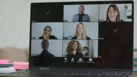 Sliding-Medium-Shot-of-Laptop-Screen-as-People-Join-Video-Call