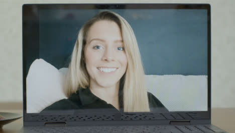 Sliding-Medium-Shot-of-Laptop-Screen-with-Young-Woman-On-Video-Call