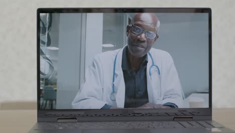Sliding-Medium-Shot-of-a-Laptop-Screen-with-Doctor-On-a-Video-Call
